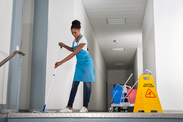 Woman Mopping Corridor - Фото, зображення