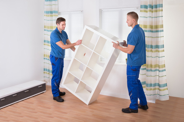 Movers Carrying Shelf At Home - Foto, imagen