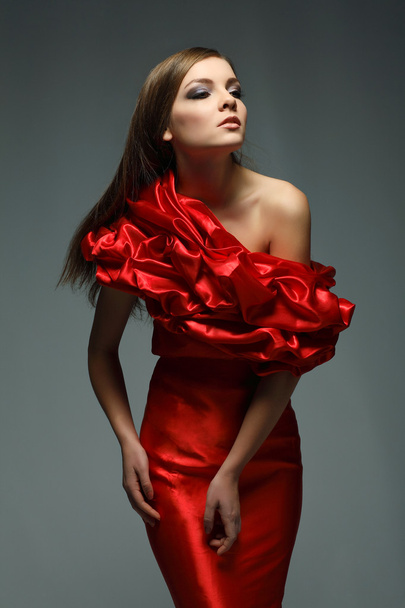 A beautiful young woman is in red clothes - Foto, Imagen