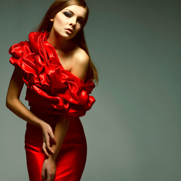 A beautiful young woman is in red clothes - Foto, Imagem