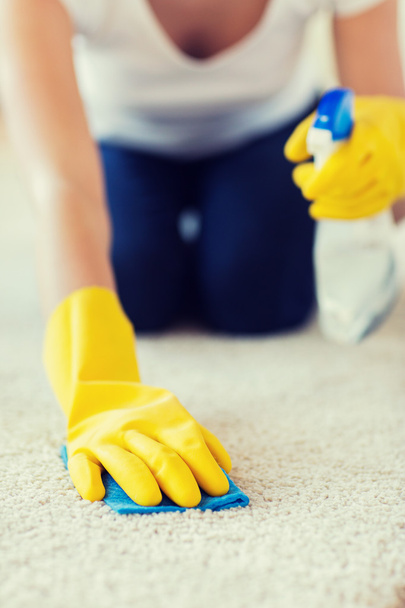 close up of woman with cloth cleaning carpet - Foto, Bild