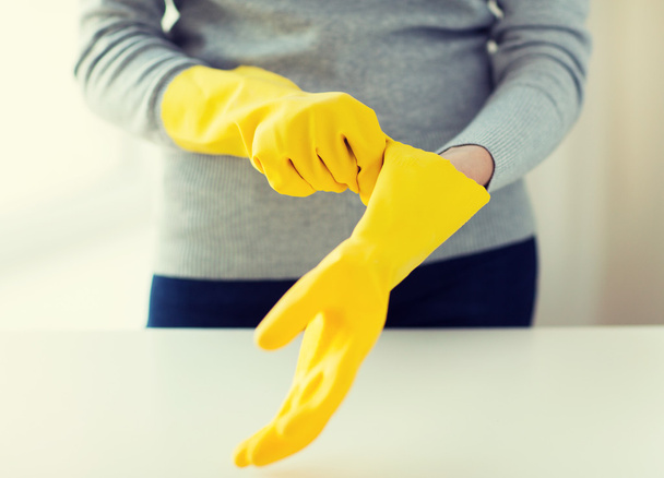 close up of woman wearing protective rubber gloves - Фото, изображение