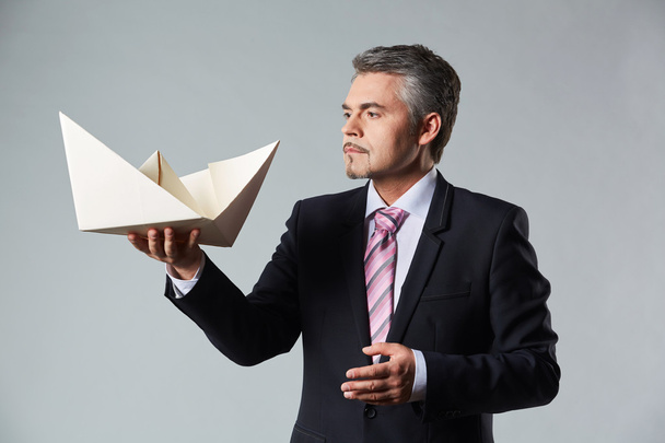 Portrait of businessman holding paper boat - Foto, Imagem