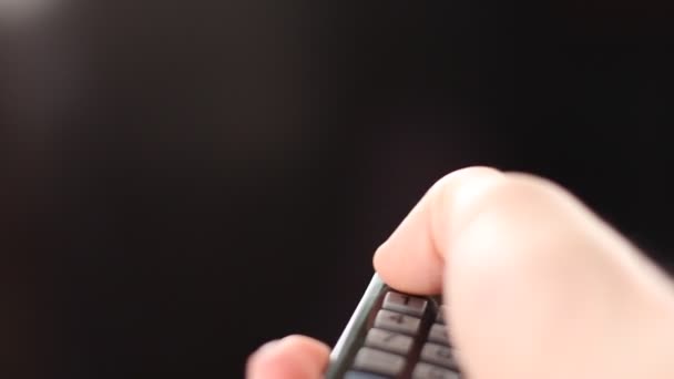 man's hand with remote control remotely turns on the TV with Chroma Key Green Screen - Video