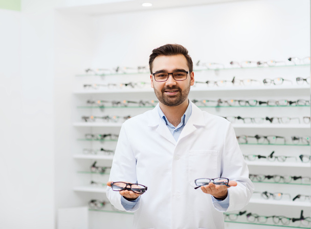 man optician with glasses in coat at optics store - Valokuva, kuva