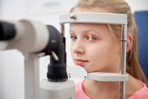 girl checking vision with tonometer at eye clinic - Foto, imagen