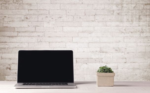 Business laptop with white brick wall - Fotografie, Obrázek