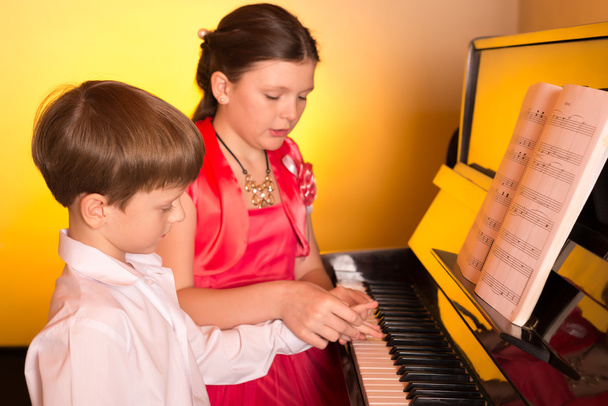 Brother And Sister Playing Piano. Piano player. - Photo, Image