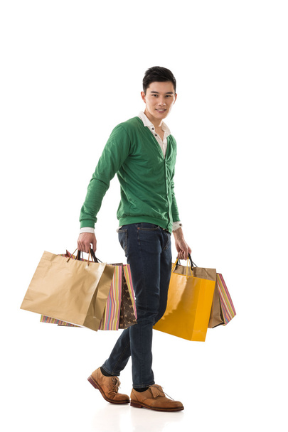 買い物袋を持ってアジアの若い男 - 写真・画像