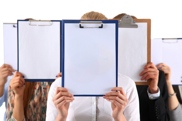 Team of businesspeople holding a folders near face isolated on white background - Fotoğraf, Görsel