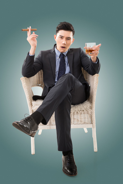 businessman holding a cigar - Фото, изображение