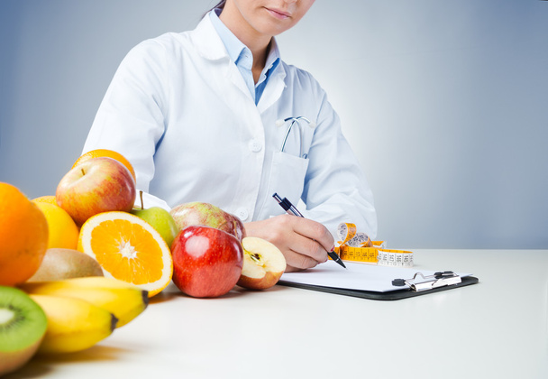 Professional nutritionist writing medical records - Photo, Image