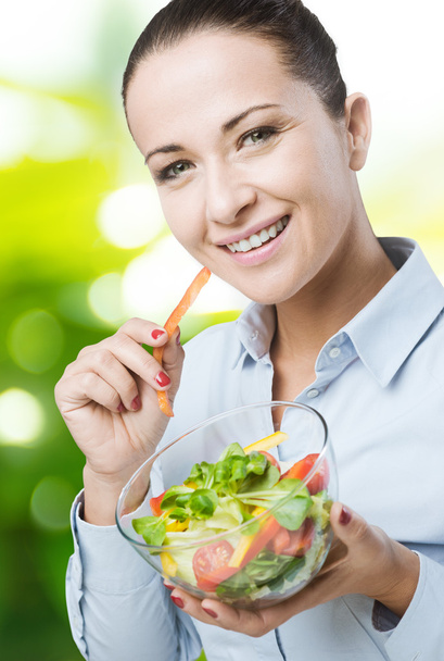 Cheerful woman eating salad - Photo, Image