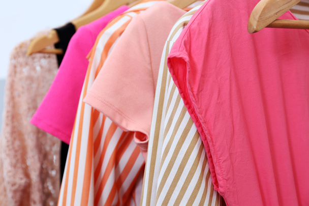 Female clothes on hangers, closeup - Foto, afbeelding