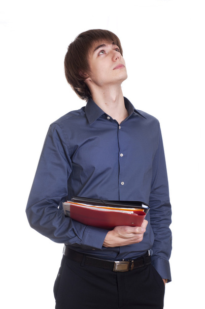 Young businessman hold a folder with documents and think about s - Photo, Image