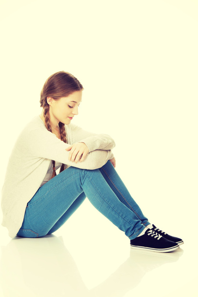 Depressed teen woman sitting. - Zdjęcie, obraz