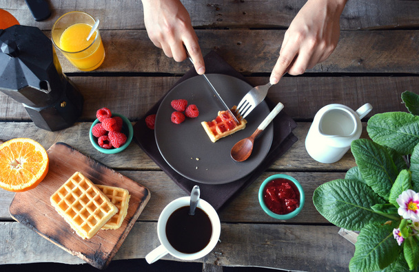overhead photograph of person with breakfast waffles with marmal - Zdjęcie, obraz