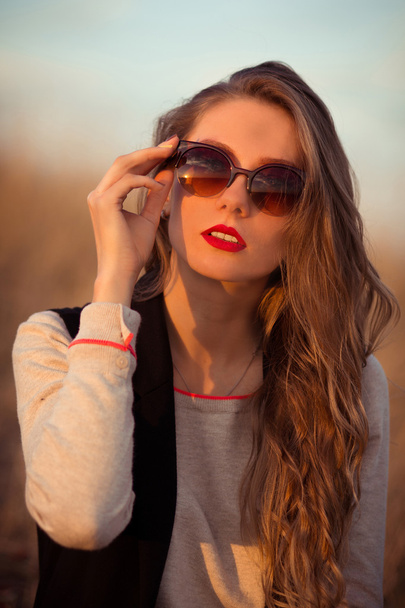 Very awesome, excellent, beautiful, attractive, snorting, stunning, fashionable, glamorous, cheerful, adorable, delightful girl with sunglasses, red lips, white teeth. - Photo, Image