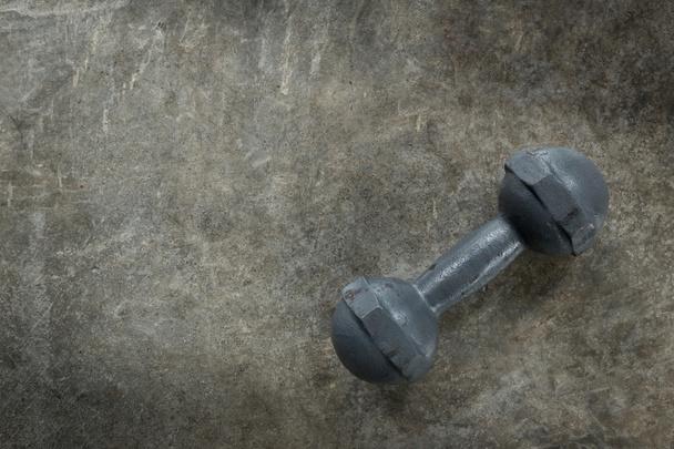 metal dumbbell on cement floor, fitness sport of bodybuilding - Photo, Image