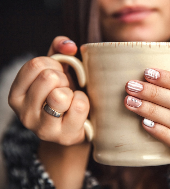 a cup of coffee in a beautiful female hands and beautiful lips - Foto, Imagen
