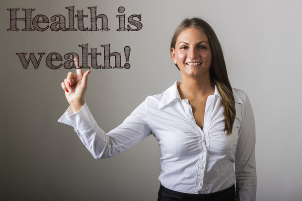 Zdraví je bohatství! -Krásná dívka se dotýká text na transparentní  - Fotografie, Obrázek