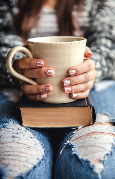 girl having a break with cup of fresh coffee after reading books or studying - Photo, Image