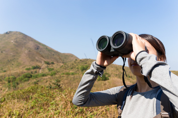 Woman looking though binocular - Photo, Image