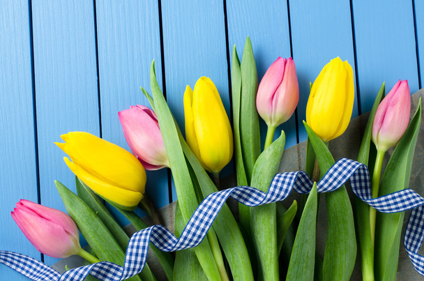 Colorful tulips on blue wooden table - Photo, Image