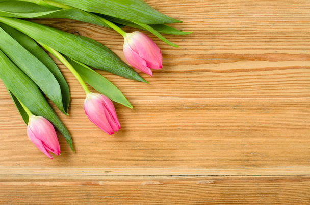 Pink tulips on an old wooden table - Photo, Image