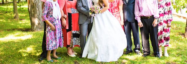 sposa e sposo in piedi con gli ospiti in giardino
 - Foto, immagini