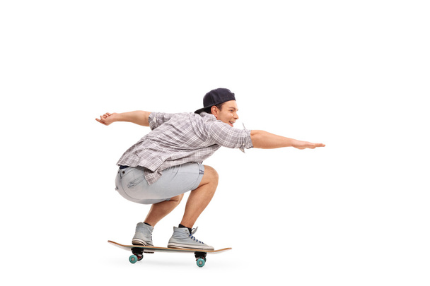 Young man riding a skateboard  - Valokuva, kuva