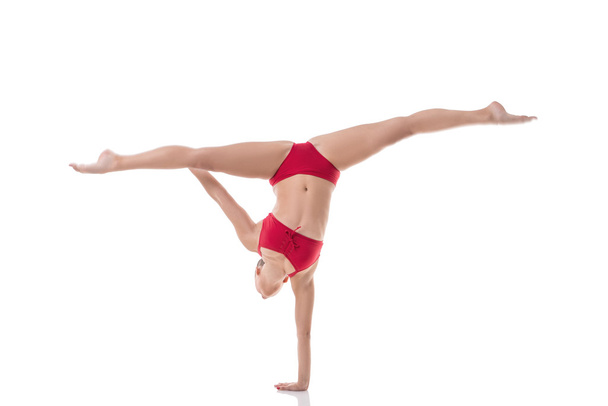Gymnast performs splits while doing handstand - Foto, Bild