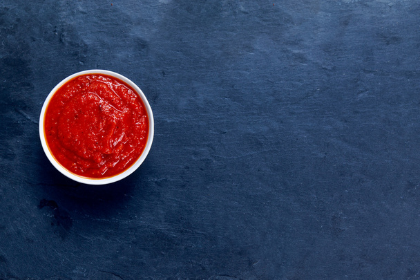 Italian Marinara sauce on stone blue background - Фото, изображение