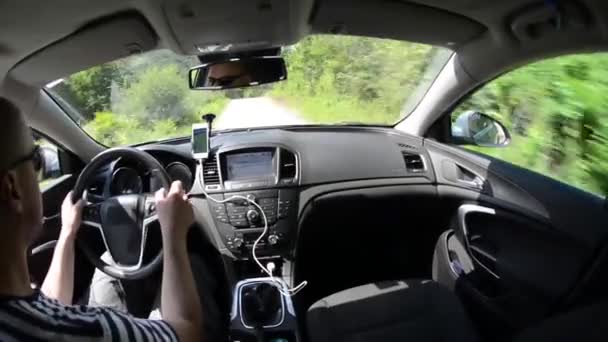 man driving a car with gps navigation system - Séquence, vidéo