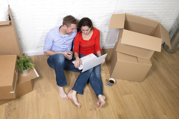 couple sitting on floor moving in a new house or apartment flat  - Photo, Image