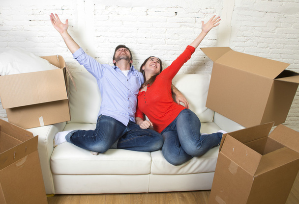 happy American couple lying on couch together celebrating moving - Fotoğraf, Görsel