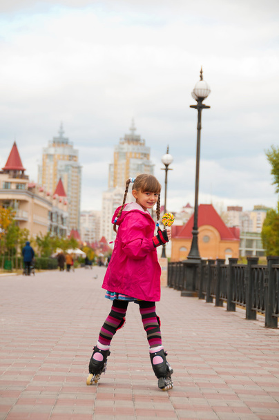 A girl on roller skates coming down the road. - Φωτογραφία, εικόνα