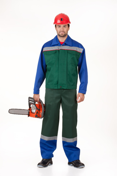 Man In The Uniform With The Petrol Saw - Φωτογραφία, εικόνα