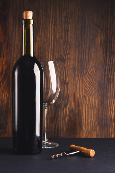 Full bottle of wine, empty glass and corkscrew - Foto, Imagem