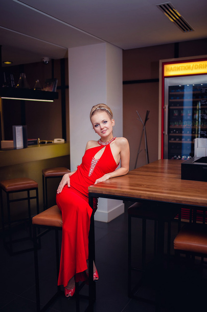 The girl in the red dress near the bar - Photo, image