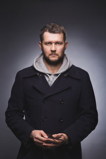portrait of serious man in knitted jacket and blue pea coat over - Fotoğraf, Görsel
