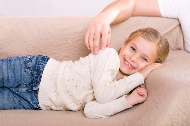 Cute little girl lying on the sofa - Valokuva, kuva