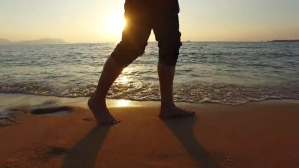4k pannen man loopt in ondiepe zee bij zonsondergang 3840 x 2160 - Video