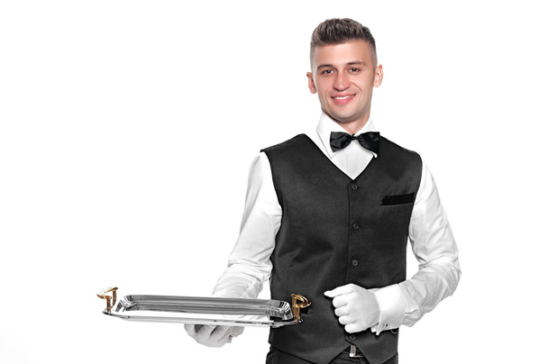 Portrait of young happy smiling waiter with on tray isolated on  - Photo, Image