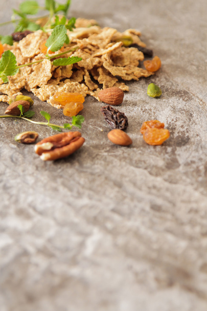 muesli with nuts and dried fruits mint leaves - Fotó, kép