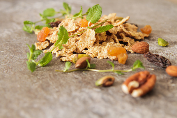 muesli with nuts and dried fruits mint leaves - Фото, изображение