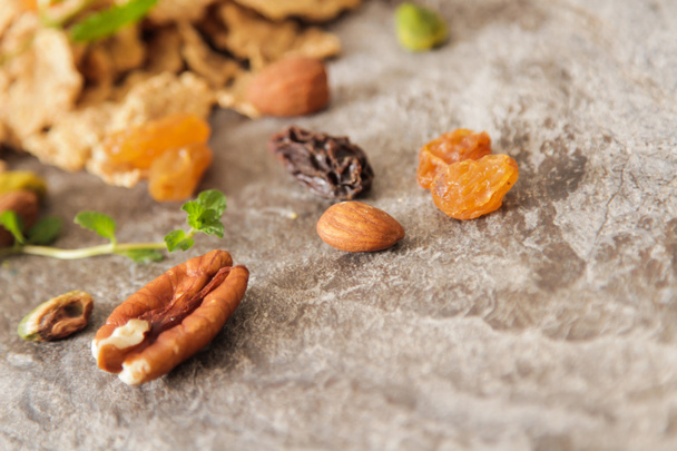 muesli with nuts and dried fruits mint leaves - Фото, изображение
