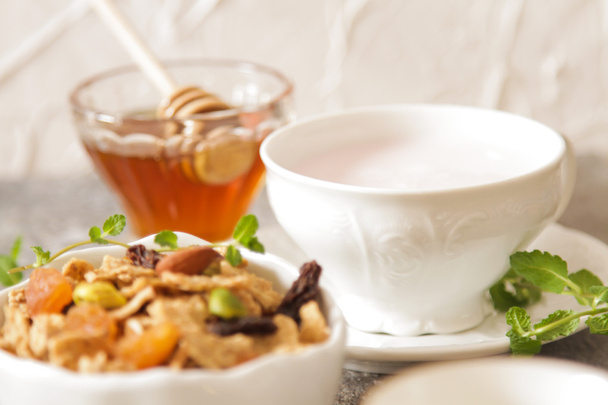 cup of muesli with strawberry milk and honey - Фото, изображение