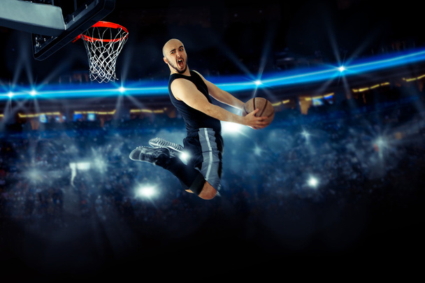 Horizontal photo of basketball player in the game makes reverse  - Zdjęcie, obraz