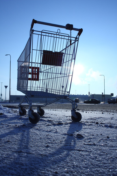 Image of empty shopping cart on empty parking near huge store - Photo, Image